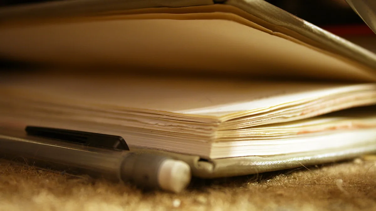 Notebook and Mechanical Pencil for a Book Annotation Key and Page Index Close view of a well used notebook lying open beside a mechanical pencil, ready for a book annotation key and page index