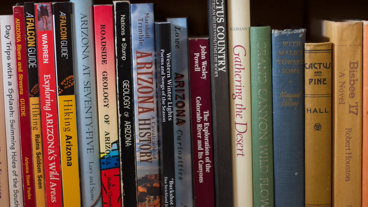 Books Grouped by Subject on a Home Shelf Row of Arizona travel, geology and history books shelved together, a subject-based bookshelf organization idea