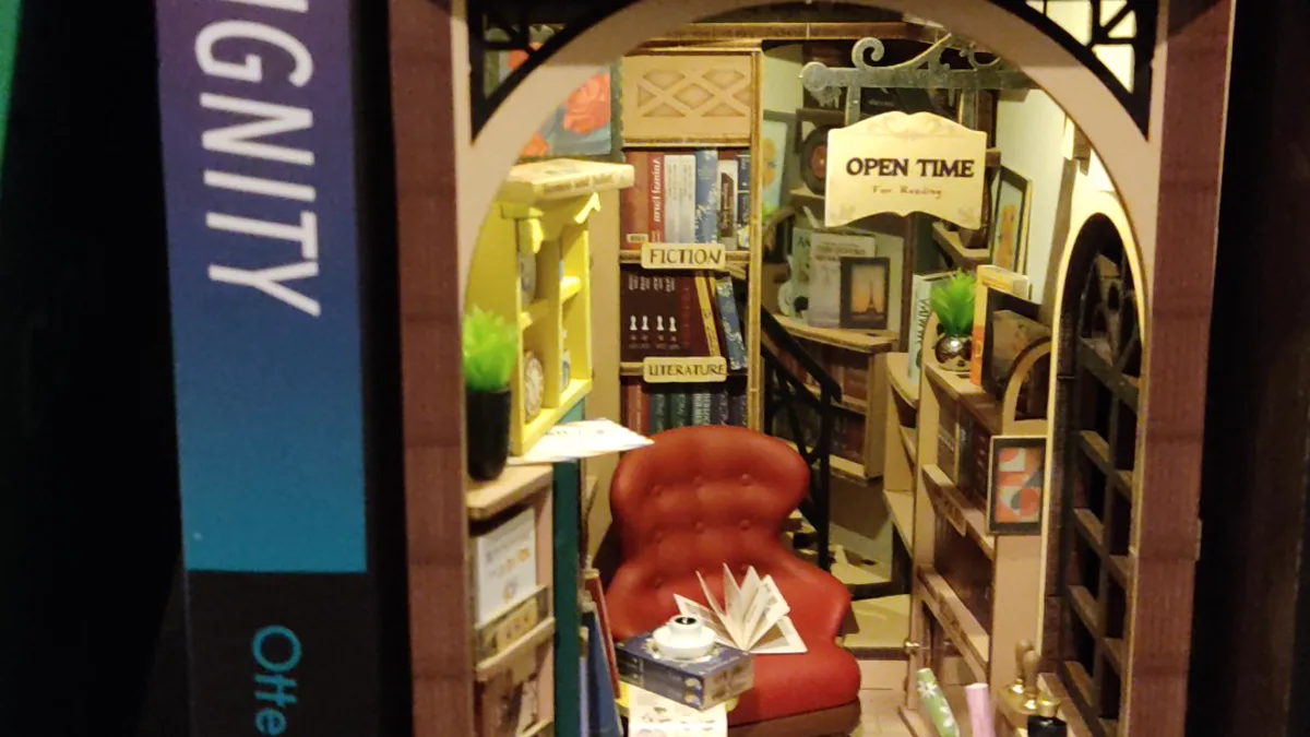 cozy reading routines in quiet armchair beside wooden bookshelf