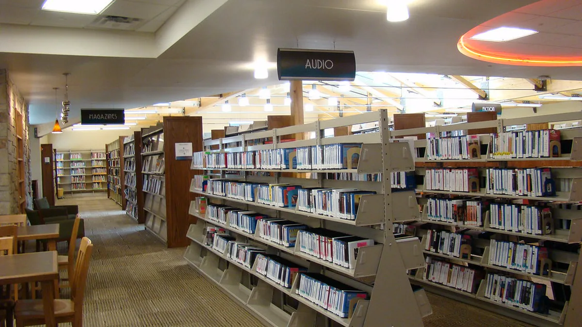 Audio Shelves at the Bonner Springs Library Rows of audiobook cases on angled shelves under an Audio sign in a public library, where library audiobooks are free to borrow