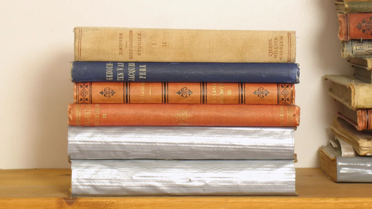 Old Hardcovers Stacked Flat on a Wooden Shelf Small stack of old cloth-bound hardcovers lying flat on a wooden shelf, a gentle way to store books too fragile to stand